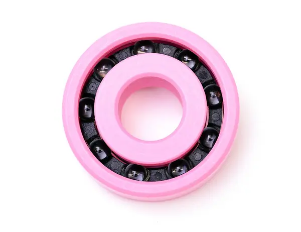 白色底座上的粉色塑料轴承 — 图库照片