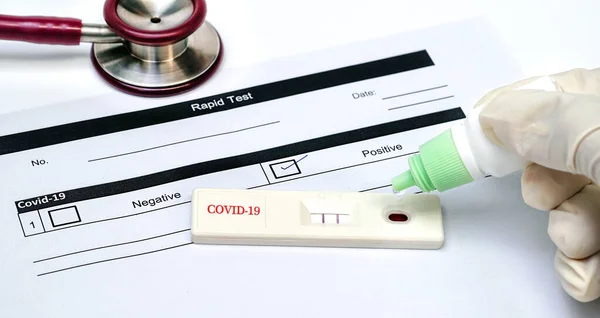 Doctor holding a test kit for viral disease COVID-19