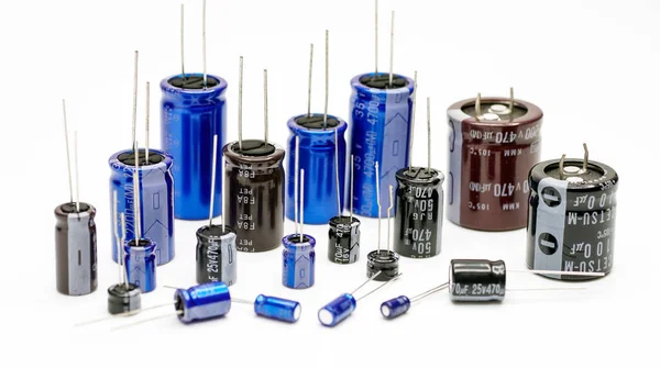 stock image Group of capacitors different sizes isolated on white background. Electronic parts concept.