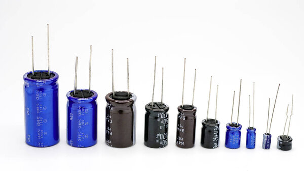 Group of capacitors different sizes isolated on white background. Electronic parts concept.