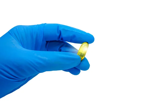 stock image Doctor wearing blue glove holding capsule on white with clipping path