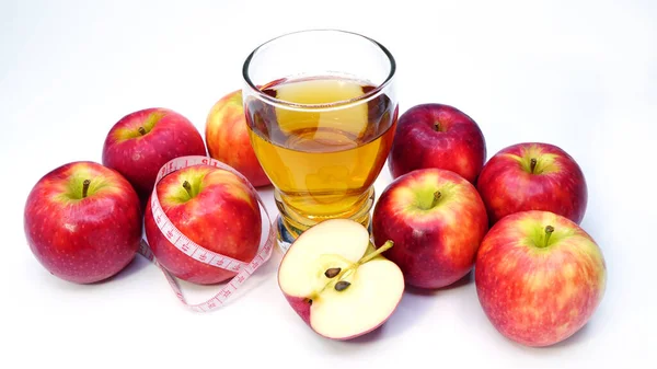 Apple cider vinegar, apple and apple juice with tape measure. healthy food, drink for weight control in summer. Health care ideas for weight loss.
