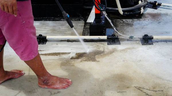 Clean the cement floor with a high-pressure cleaner. Deck floor