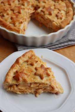 Cut Italian Timballo or Timbale filled with pasta and bechamel with tomato sauce on wooden table