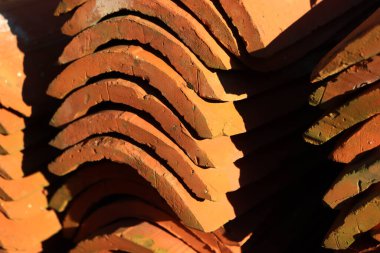 Eski kırmızı kiremitlerden yapılmış yığının yakın çekimi. Seçici odak üzerinde terracottadan yapılmış başlıklar