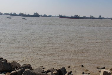 Patenga Denizi Sahili, Bengal Körfezi, Bangladeş 'te çoklu kargo gemisi demirlemiş. Deniz aktivitesi, sakin deniz manzarası ve geniş okyanus manzarası var. Seyahat, nakliye ve manzara fotoğrafçılığı için mükemmel..