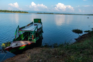 Bangladeş 'teki Kaptai Gölü' nün berrak sularında sıralanmış ahşap kayıklar. Seyahat fotoğrafçılığı, tekne maceraları, eko-turizm ve huzurlu doğal manzaraları yakalamak için mükemmel sakin ve manzaralı bir tropikal yer..