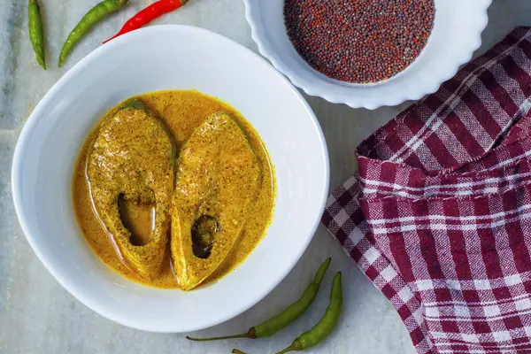 popular Bengali Illish/Hilsa fish curry with grinned poppy seed.