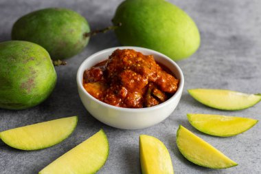 selective focus of Mango Pickle with green sliced mango.  clipart