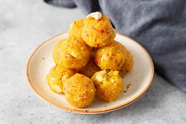 stock image Indian Sweets laddoo or Laddu made of gram flour on a grey background. 