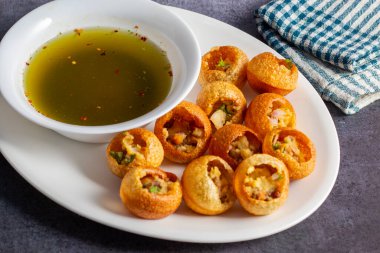 Exploring the Tangy, Spicy, and Refreshing Delight of Pani Puri. India's Favourite Street Food Experience. Selective focus.  clipart