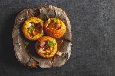 Exploring the Tangy, Spicy, and Refreshing Delight of Pani Puri. India's Favourite Street Food Experience. Selective focus.  clipart