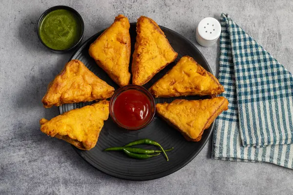 stock image Selective Focus of Bread pakora is a popular Indian street food made with bread, stuffed with spicy potato filling, coated in chickpea flour, and deep-fried.