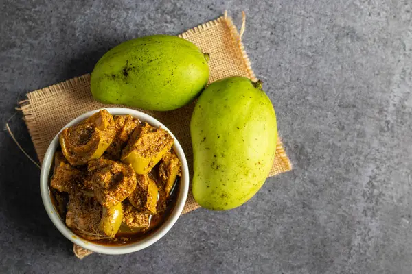 stock image Flavors of India, Tangy and Spicy Mango Pickles on a ceramic jar with Traditional Homemade Goodness and Exotic Spices. Selective focus. 