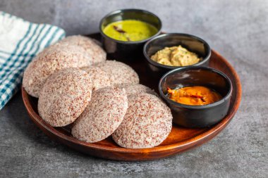 Ragi idli is a healthy, steamed South Indian dish made from fermented ragi (finger millet) batter, soft, and nutritious. clipart