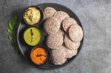 Ragi idli is a healthy, steamed South Indian dish made from fermented ragi (finger millet) batter, soft, and nutritious. clipart