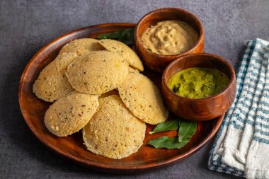 Oats Idli is a healthy, steamed South Indian breakfast made with oats, semolina, yogurt, and spices, offering a nutritious twist. Selective focus. clipart