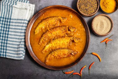 Pabda fish curry is a Bengali delicacy, featuring tender pabda fish in a rich, spiced gravy with mustard and turmeric. Selective focus.  clipart