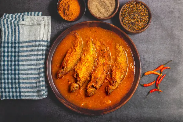 stock image Pabda fish curry is a Bengali delicacy, featuring tender pabda fish in a rich, spiced gravy with mustard and turmeric. Selective focus. 