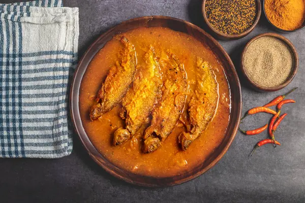 stock image Pabda fish curry is a Bengali delicacy, featuring tender pabda fish in a rich, spiced gravy with mustard and turmeric. Selective focus. 