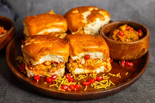 stock image Dabeli is a popular Indian street food from Gujarat, consisting of spiced mashed potatoes stuffed in a bun with chutneys.