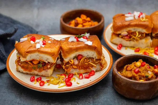 stock image Dabeli is a popular Indian street food from Gujarat, consisting of spiced mashed potatoes stuffed in a bun with chutneys.