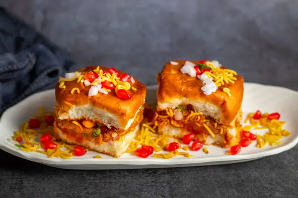 stock image Dabeli is a popular Indian street food from Gujarat, consisting of spiced mashed potatoes stuffed in a bun with chutneys.