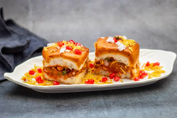 stock image Dabeli is a popular Indian street food from Gujarat, consisting of spiced mashed potatoes stuffed in a bun with chutneys.