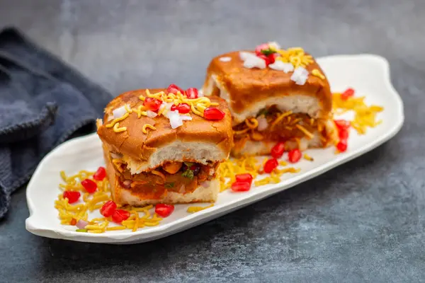 stock image Dabeli is a popular Indian street food from Gujarat, consisting of spiced mashed potatoes stuffed in a bun with chutneys.