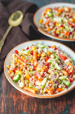 A refreshing quinoa salad with fresh vegetables, herbs, lemon dressing, and a light, nutty flavor, perfect for healthy meals. clipart