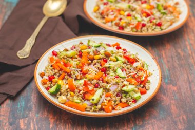 A refreshing quinoa salad with fresh vegetables, herbs, lemon dressing, and a light, nutty flavor, perfect for healthy meals. clipart