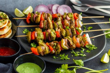 Hariyali Tavuğu Tikka Kebap nane, kişniş ve baharatlarla marine edilmiş mükemmel ızgara edilmiş tavuk ile yapılan lezzetli bir Hint yemeğidir..