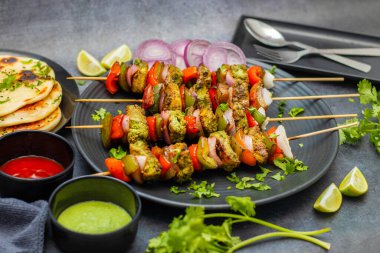 Hariyali Chicken Tikka Kabab is a flavorful Indian dish made with chicken marinated in mint, coriander, and spices, grilled perfectly. clipart