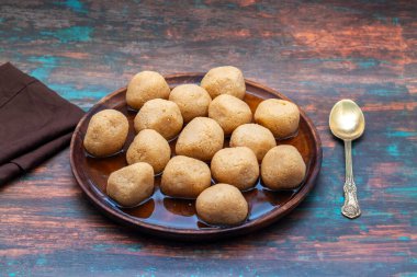 Delightful Nolen Gurer Rosogolla, A Sweet Bengali Tradition with Rich Flavors and Unique Date Palm Jaggery Essence clipart