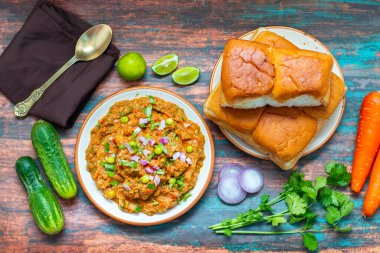 Pav Bhaji is a spicy, mashed vegetable curry served with buttered, toasted bread rolls, commonly enjoyed as a street food. clipart