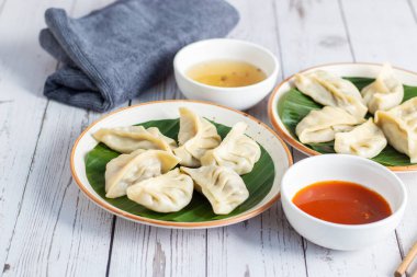 Momo, Nepal, Tibet ve Butan 'da baharatlı turşuyla servis edilen et ya da sebzelerle dolu buğulanmış ya da kızartılmış hamur köfteleri..