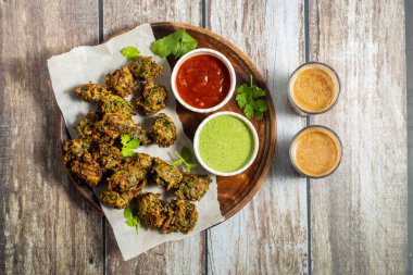 Palak ke pakore gevrek, bol yağda kızartılmış ıspanaklı börek besan, baharat ve taze ıspanak yapraklarıyla yapılır, acılı ve çay ile servis edilir..