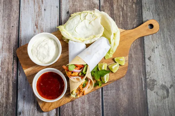 Tavuk shawarma dürümü baharatlı ızgara tavuk, sarımsak sosu, sebze turşusu ve taze ekmek ile yapılan bir Orta Doğu dürümü..