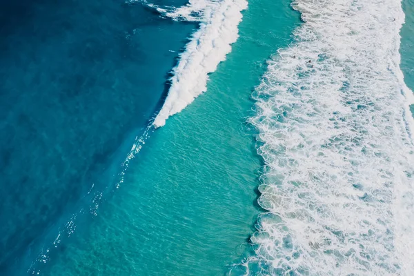 Top view of blue ocean and waves, aerial view