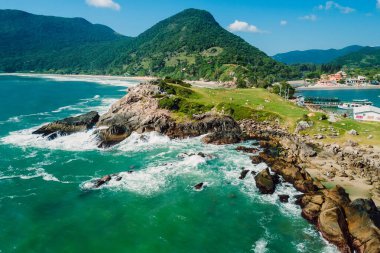 Coastline with rocks, mountains, beach and ocean in Brazil. Aerial view of Matadeiro beach and Ponta das Campanhas