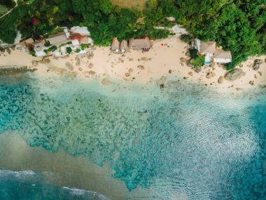 Aerial view of blue ocean and coastline with cozy hotels on Impossibles beach in Bali island clipart