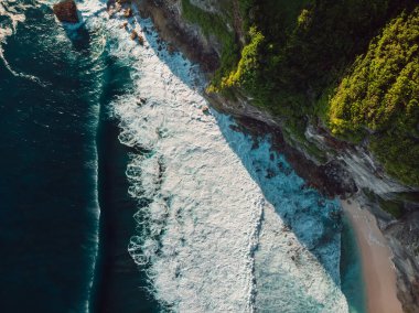 Amazing coastline with rocks and ocean with waves in Bali. Aerial view