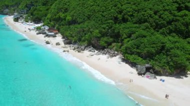 Aerial view of blue transparent ocean and tropical luxury beach in Bali.