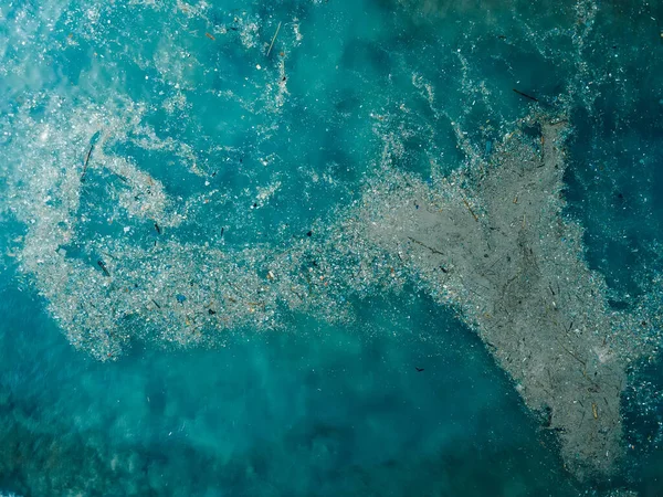 Ocean water and plastic trash island. Aerial view of pollution by plastic rubbish