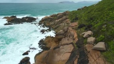 Coastline with rocks and ocean waves in Santa Catarina state, Brazil. Aerial view