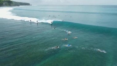 Aerial view of ocean with surfer ride on perfect wave in Bali