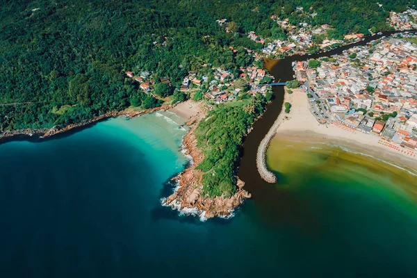 Beaches, rocks, river and ocean in Brazil. Drone view of Barra da lagoa village in Florianopolis
