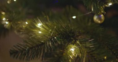 Yeni yılınız kutlu olsun Noel ağacı, arkaplandaki karla süslenir. Kış tatilinde aile tatili için yanıp sönen ampuller. Yüksek kalite 4k görüntü