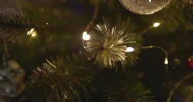 Yeni yılınız kutlu olsun Noel ağacı, arkaplandaki karla süslenir. Kış tatilinde aile tatili için yanıp sönen ampuller. Yüksek kalite 4k görüntü