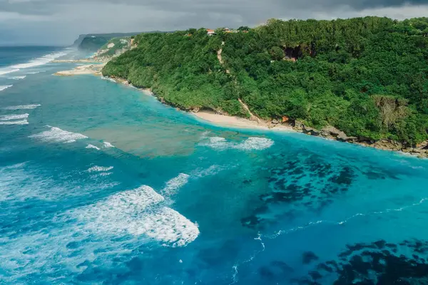 stock image Paradise beach coastline with turquoise ocean and waves in Bali. Aerial view